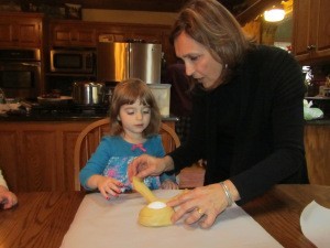 This is my Easter bread and Easter bread "baby dolls". The second picture is me showing my grandaughter how to braid the bread around the egg to make the "doll" and the third picture are 2 of my grandaughters with the end result.  All the grandchildren get their own "doll" to braid and then they draw their faces on the egg when the "doll" is cool. It is a beautiful tradition we've had since I was a little girl. The braiding shows how our families lives are all entwined in love.