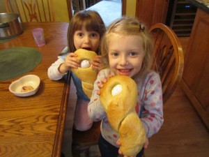 This is my Easter bread and Easter bread "baby dolls". The second picture is me showing my grandaughter how to braid the bread around the egg to make the "doll" and the third picture are 2 of my grandaughters with the end result.  All the grandchildren get their own "doll" to braid and then they draw their faces on the egg when the "doll" is cool. It is a beautiful tradition we've had since I was a little girl. The braiding shows how our families lives are all entwined in love.